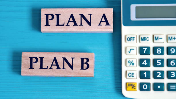 istock PLAN A and PLAN B - words on wooden blocks with a calculator in the background 1782966056