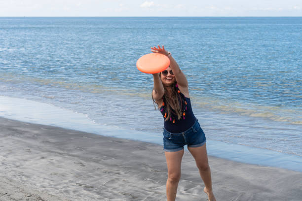 istock Mother playing Frisbee on the beach 1782978428