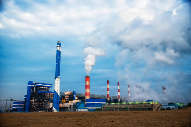 istock Power stations manufacturing electrical industrial plant. Electric power building refinery engineering smog steam smokestack. Lignite electricity chimneys release pollution in industry plant blue sky 1782993809