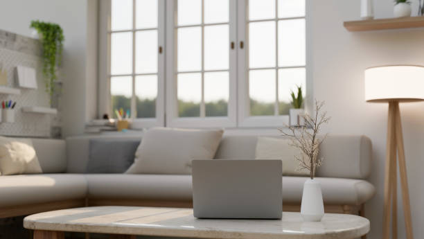 istock A laptop on a coffee table in a modern white and comfortable living room with a cosy couch. 1783028761