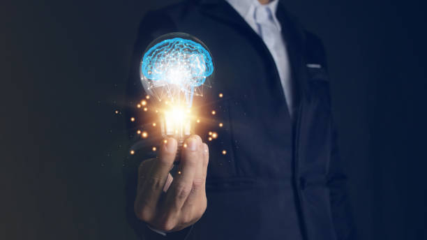 istock businessman holding a light bulb and brain inside,creative and inspiration,idea and imagination Scientific innovation with network connectivity, analysis and solution development, technological innovation. 1783049208
