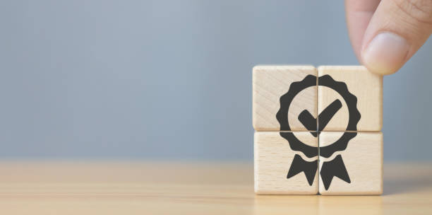 istock Quality Assurance Concept Human hand putting wooden cube with quality assurance icon on wooden cube and copy space. 1783050302