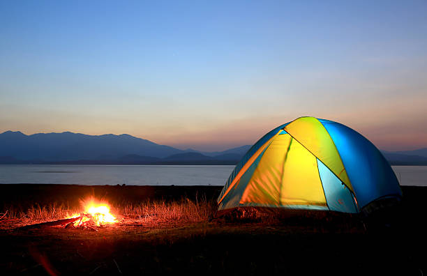 istock tent and campfire at sunset,beside the lake 178305293