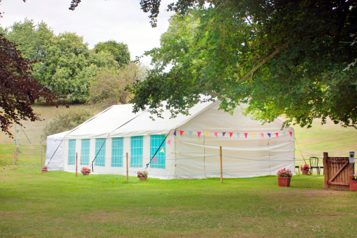 summer garden with a marquee tent on the grass