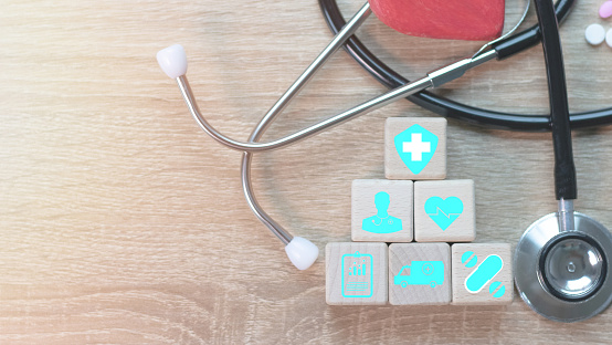 Medical icons on wooden cubes with medical network connection increased public health care Growth of health and life insurance business