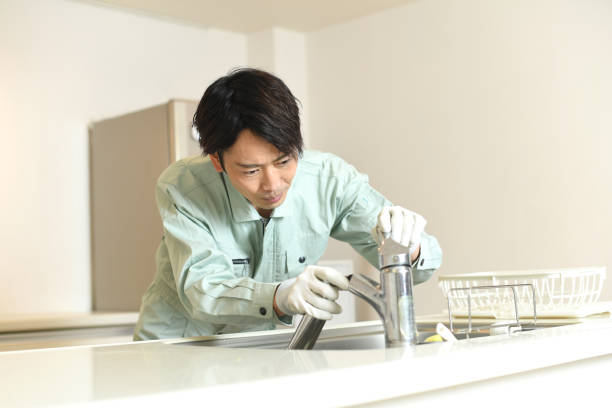 istock Asian male worker checking water faucet in kitchen at home 1783068224