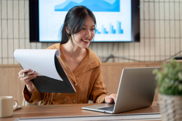 istock A beautiful Asian businesswoman is working on her laptop and analyzing financial data. 1783070902