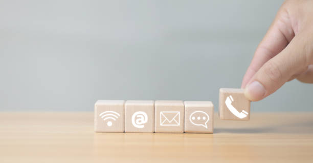 istock Website pageContact us or email marketing ideas Customer Support HotlineContact us Connecting people Wooden cubic handle with email, phone call, address, chat message icon 1783079636