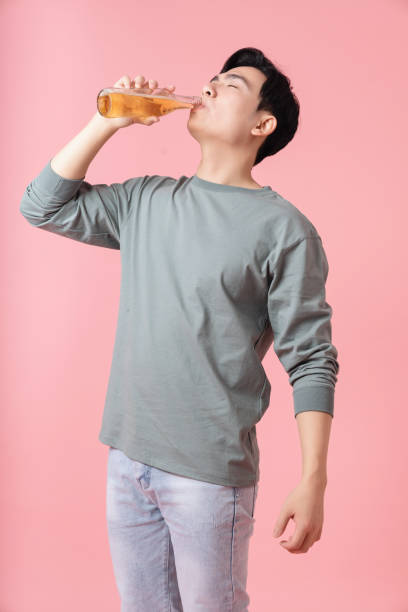istock Photo of young Asian man drinking alcohol on background 1783096703
