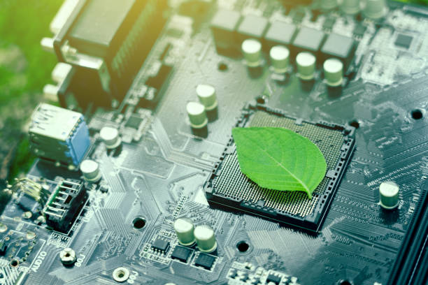 Green leaves inside a computer circuit board green technology and environmental technology Nature combined with digital technology. stock photo