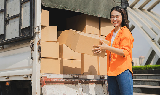 Photo of young Asian delivery woman working
