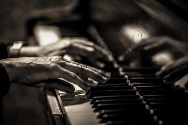 Pianist playing a grand piano.