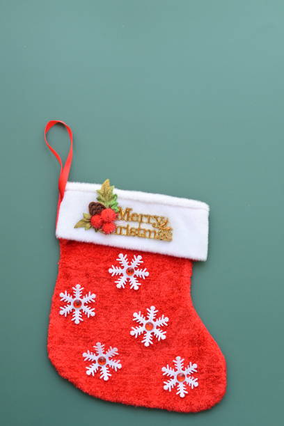 istock red wool winter sock on green background, christmas decoration 1783161128