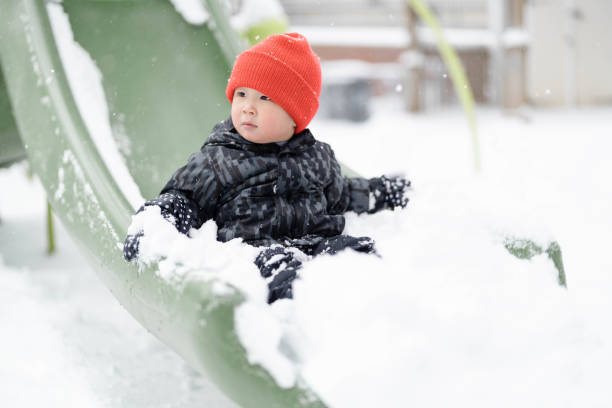 istock Winter Slide Adventures: Boy's Playful Fun on a Snowy Day 1783164376
