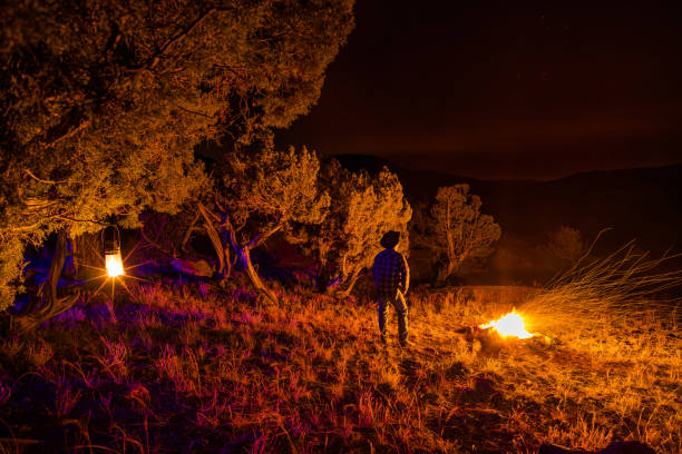 istock Cowboy at Camp with Fire Under Stars 1783190109