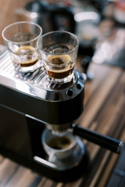 istock Glasses with black coffee stand on a carob coffee machine 1783191773