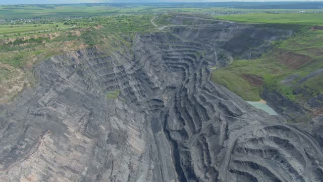 Open pit coal mining in open pit quarry aerial footage. Coal mine industry.