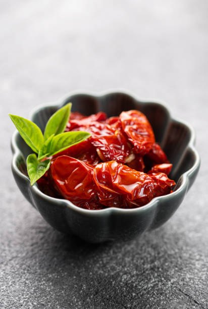 istock Bowl with sun dried tomatoes with fresh herbs and spices. 1783253368
