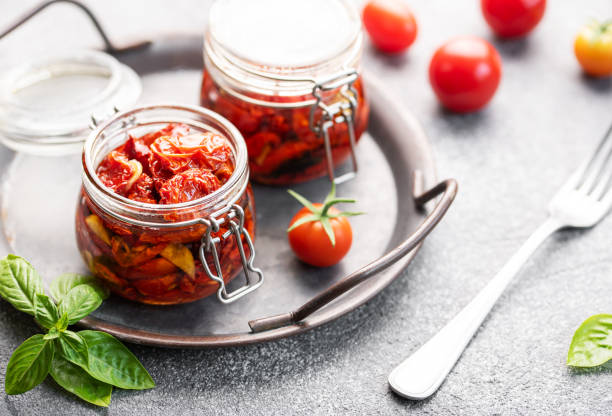 istock Jars with sun dried tomatoes with fresh herbs and spices. 1783253370