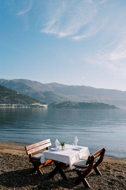 istock Laid table stands on the beach overlooking the mountains 1783266825