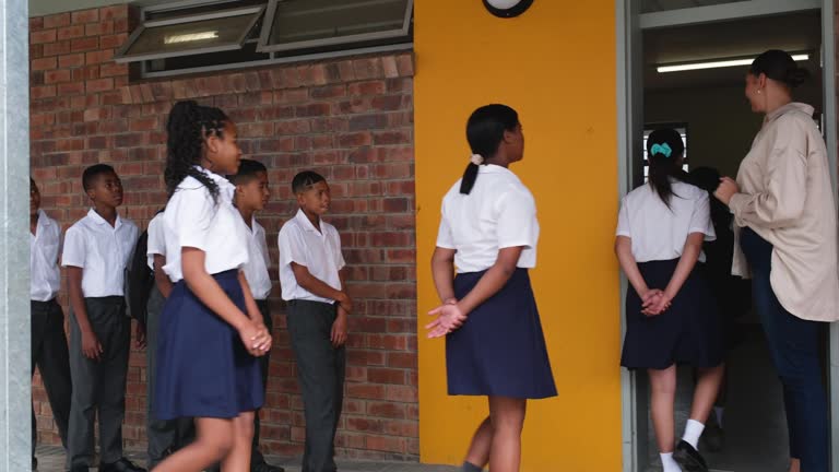 School children arriving at their classroom to start the school day