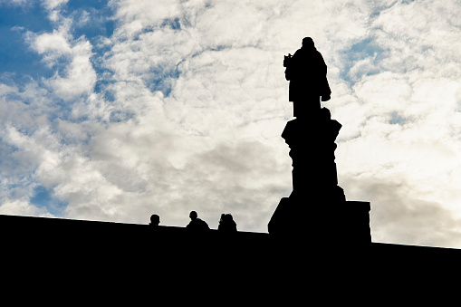 Silhouette of a statue on the Charles Bridge