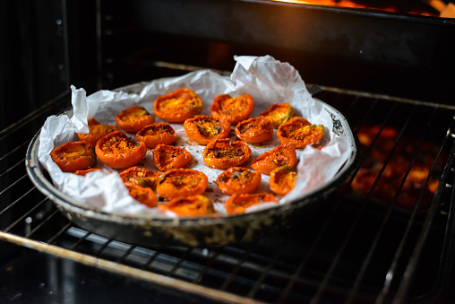 Cooking sun-dried tomatoes in the oven in the kitchen