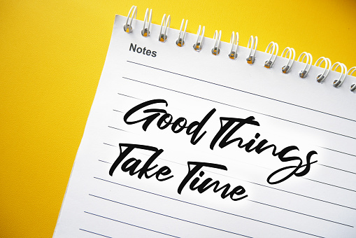 Good Things Take Time text on spiral notepad, concept for motivational slogan, Motivational Quote.