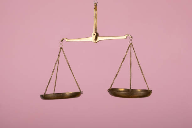 istock man hand holding a balance on pink background 1783300007