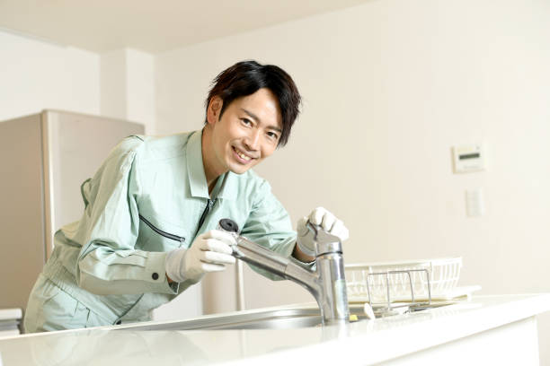 istock Asian male worker checking water faucet in kitchen at home 1783300199