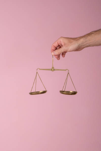 istock man hand holding a balance on pink background 1783301697