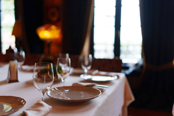 istock An empty wine glass and plates on a table served for a banquet. 1783308312
