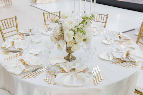 istock Round table at wedding event for six people with classic dishes, silverware,white table textiles. 1783324240