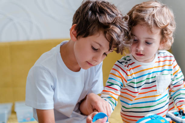 istock Kid collects robot from plastics details and programmed on tablet, robotics. 1783332626