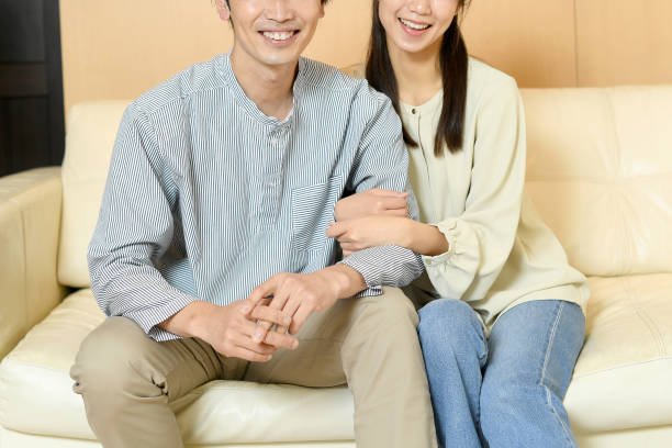 istock Young Asian couple cuddling on the sofa 1783334884