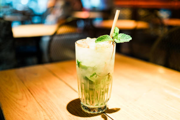 istock Mojito alcoholic cocktail with mint, lime slices and ice on a bar.Selective focus image 1783337007