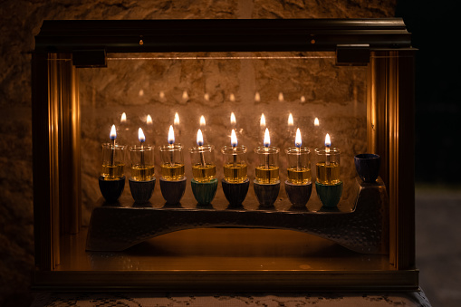 Burning Hanukkah candles cast a golden glow of firelight in the Old City of Jerusalem on the eighth night of the Festival of Lights in Israel.