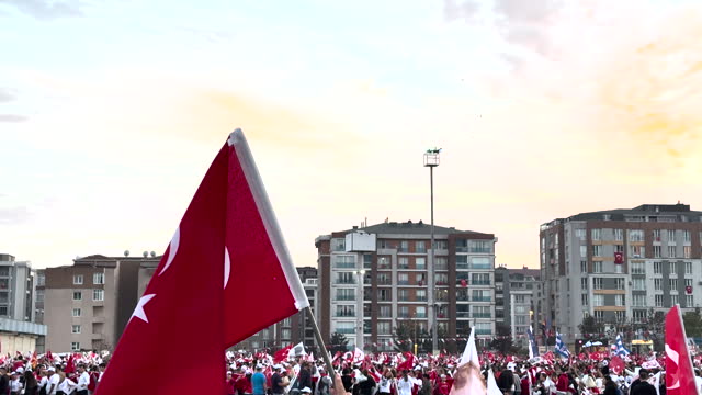 Hands holding Turkish flags