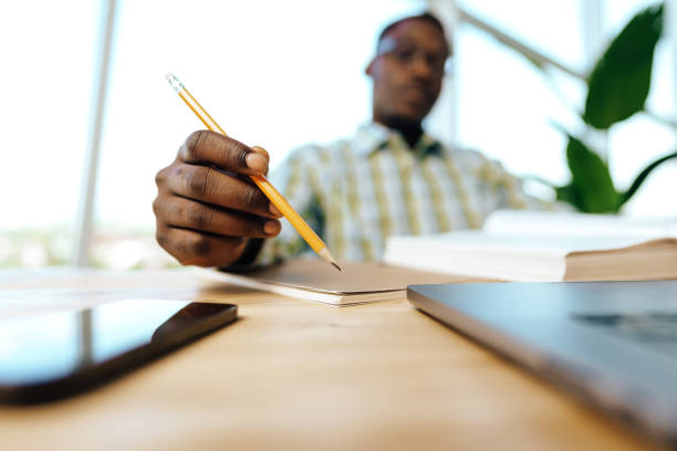 istock Serious concentrated african man studying or working with laptop indoors 1783345251