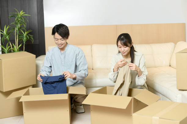 istock Asian couple packing in cardboard boxes 1783345817