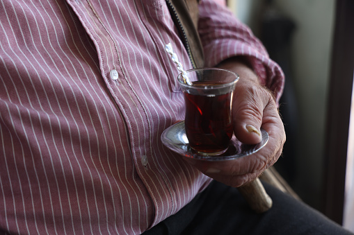 Senior holding Turkish tea