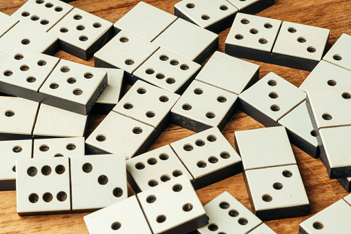 Domino game on brown wooden background close up photo