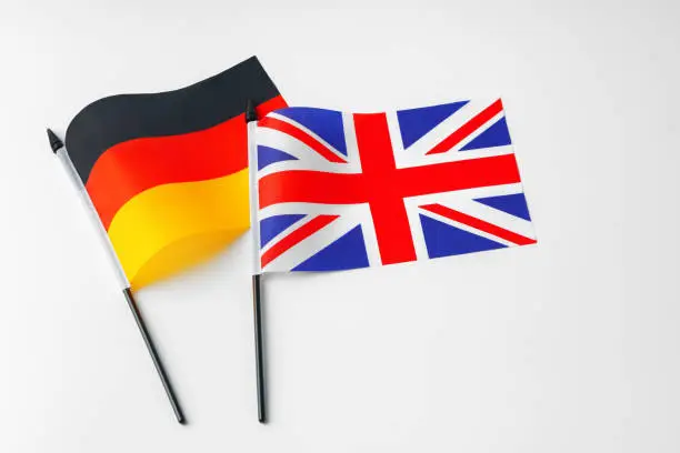 Photo of Flags of Great Britain and national flag of Germany on white