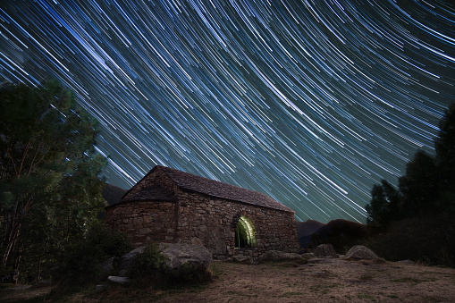 Romanesque Hermitage of Sant Quirc under star trails sky at night