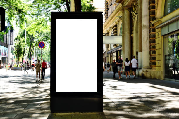 istock blank white billboard, lightbox ad along sidewalk. outdoor advertising sign panel mockup. European streetscape 1783371298