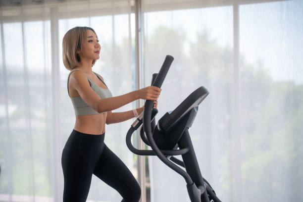 istock Young woman running on a treadmill indoors 1783375799