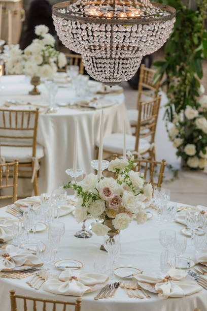 istock Wedding in white tones. Stylish wedding table with classic bouquets, silverware snow-white napkins. 1783375813