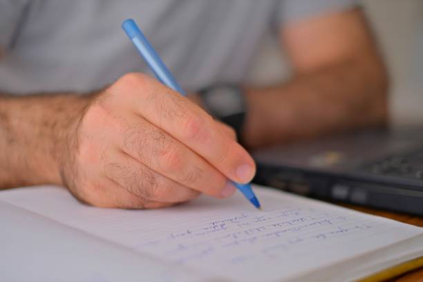 istock Notebook, pen and hands of man writing, planning and working on calendar schedule for corporate business event. Paper, receptionist and secretary with pencil, planner and journal for message notes 1783377419
