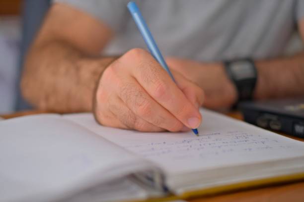 istock Hand, book and a architect woman writing a note in her journal, diary or planner to remember an appointment. Planning, schedule and notebook with a female engineer sitting in her office closeup 1783377973