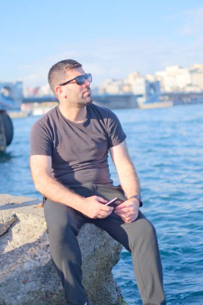 istock Handsome man with glasses is watching the sea 1783391343